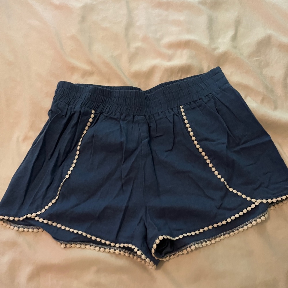 Blue shorts with white puff ball lining